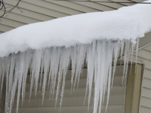 Roof Damage. Ice dams on roof of home.