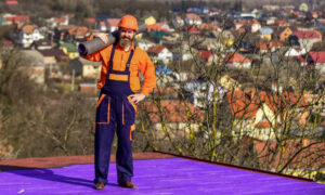 Flat Roof Replacement. Professional standing on flat roof.